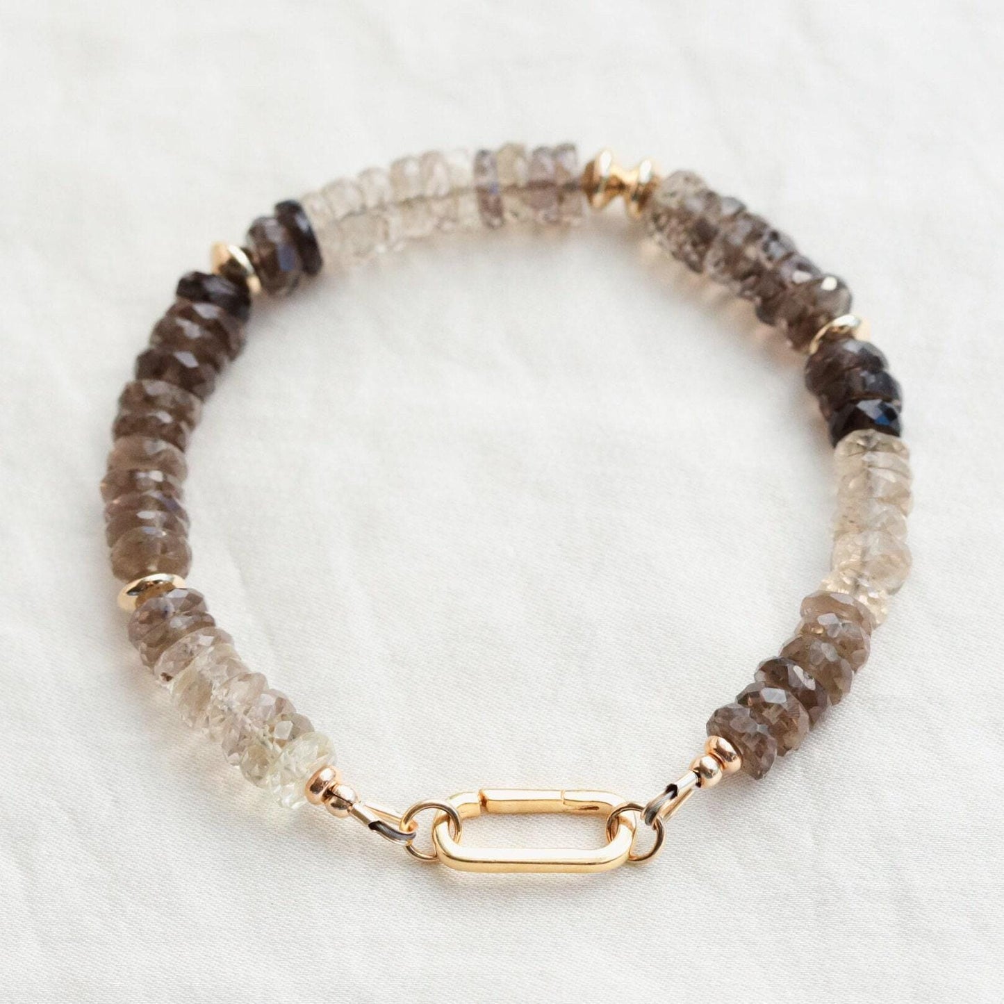 Faceted smoky quartz bracelet from Earthly Abundance featuring polished, dark, translucent stones on a delicate elastic band.