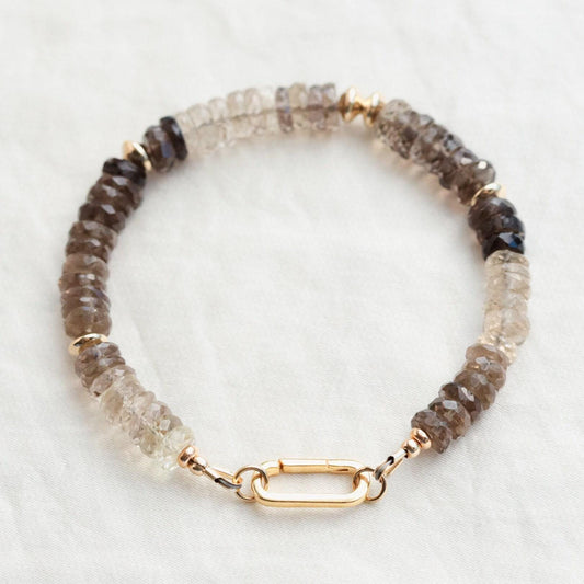 Faceted smoky quartz bracelet from Earthly Abundance featuring polished, dark, translucent stones on a delicate elastic band.