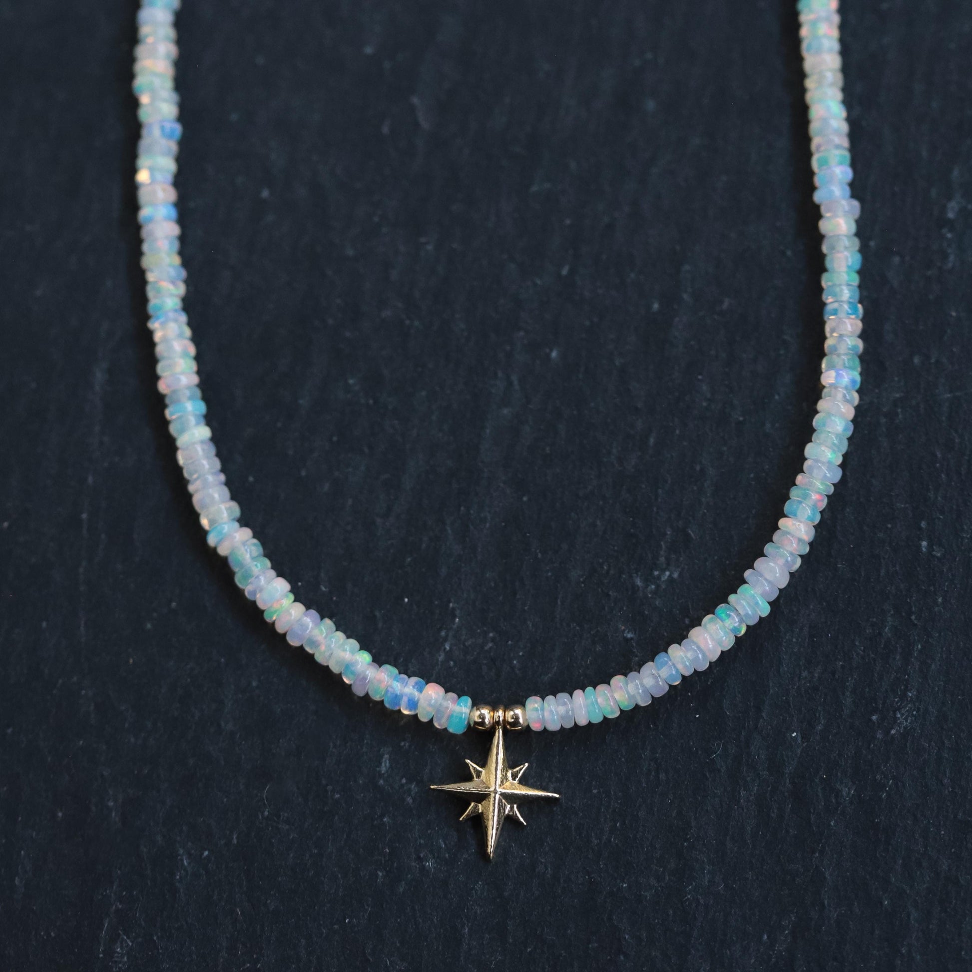 Ethiopian Opal North Star necklace with 14K gold chain from Earthly Abundance, featuring a vibrant opal star pendant.