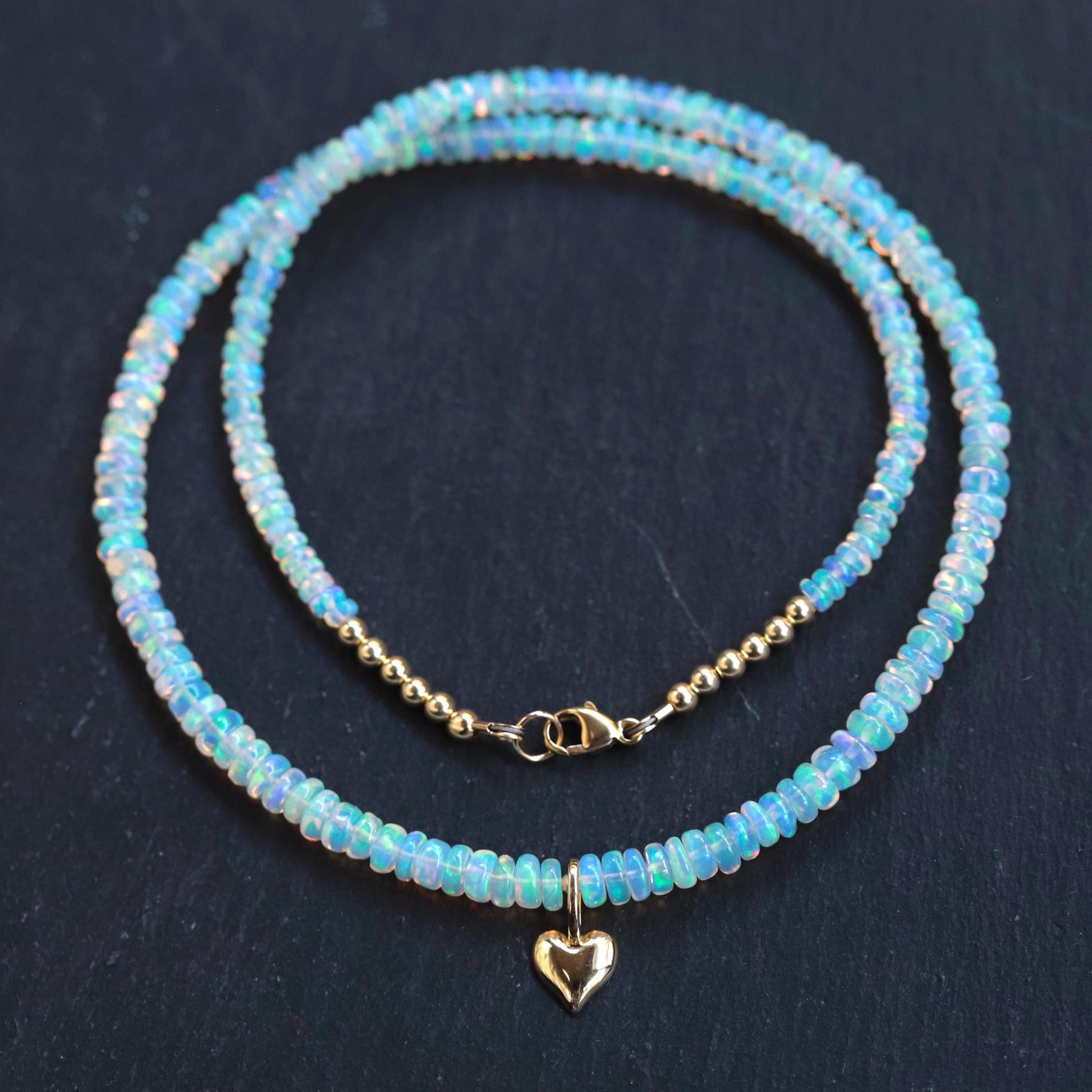 Ethiopian Opal heart necklace with 14K gold chain, showcasing a vibrant, polished heart-shaped opal pendant.