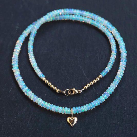 Ethiopian Opal heart necklace with 14K gold chain from Earthly Abundance, showcasing a vibrant, heart-shaped gemstone pendant.
