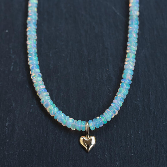 Ethiopian Opal heart necklace in 14K gold from Earthly Abundance, showcasing a sparkling heart-shaped opal pendant.