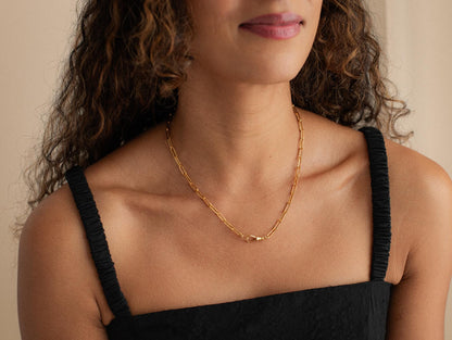 14K gold-filled swivel paperclip chain from Earthly Abundance, featuring shiny interlocking paperclip links on a white background.
