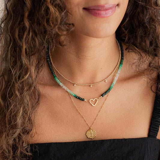 Emerald heart-shaped 14K gold carabiner necklace with a delicate chain from Earthly Abundance.