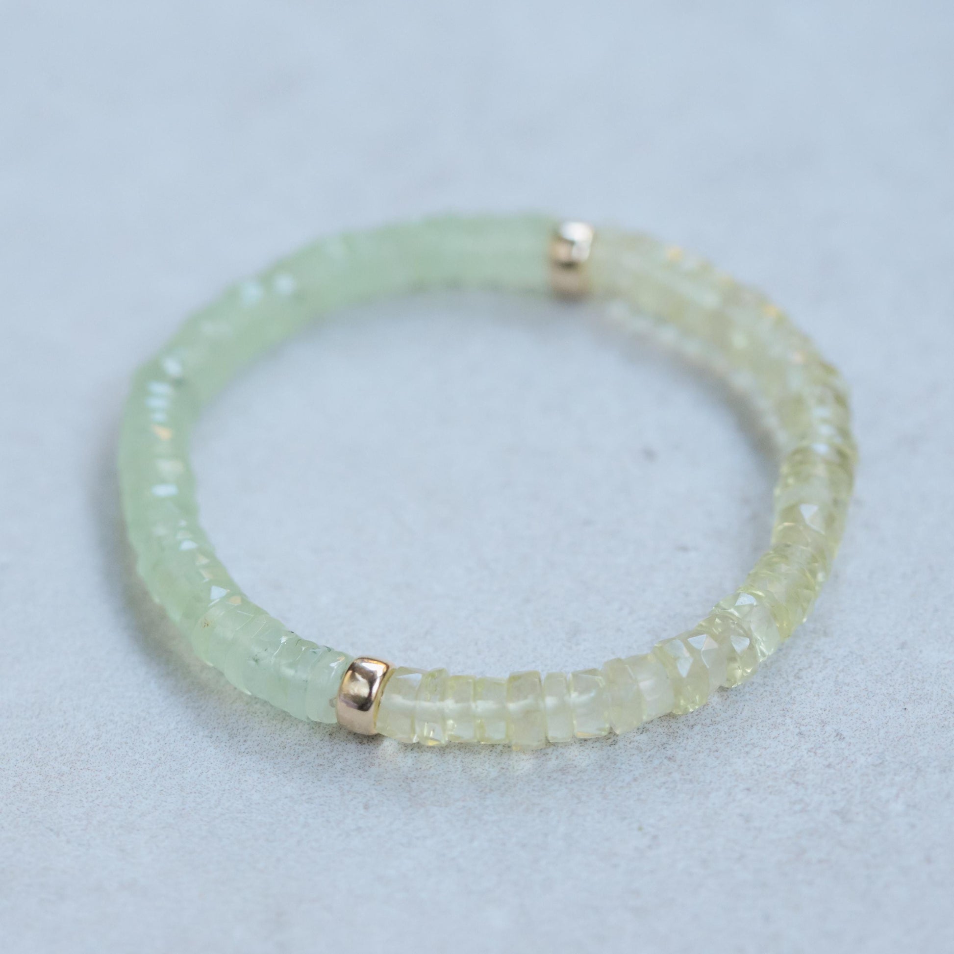 Prehnite and lemon quartz beaded bracelet from Earthly Abundance with polished stones and elastic band for a stylish, natural look.