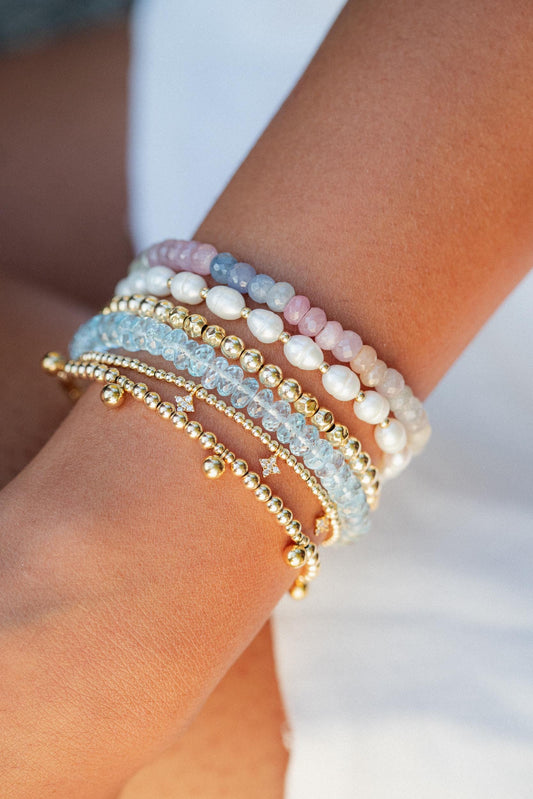 Multi sapphire bracelet by Earthly Abundance featuring vibrant blue and pink sapphires on a delicate silver chain.