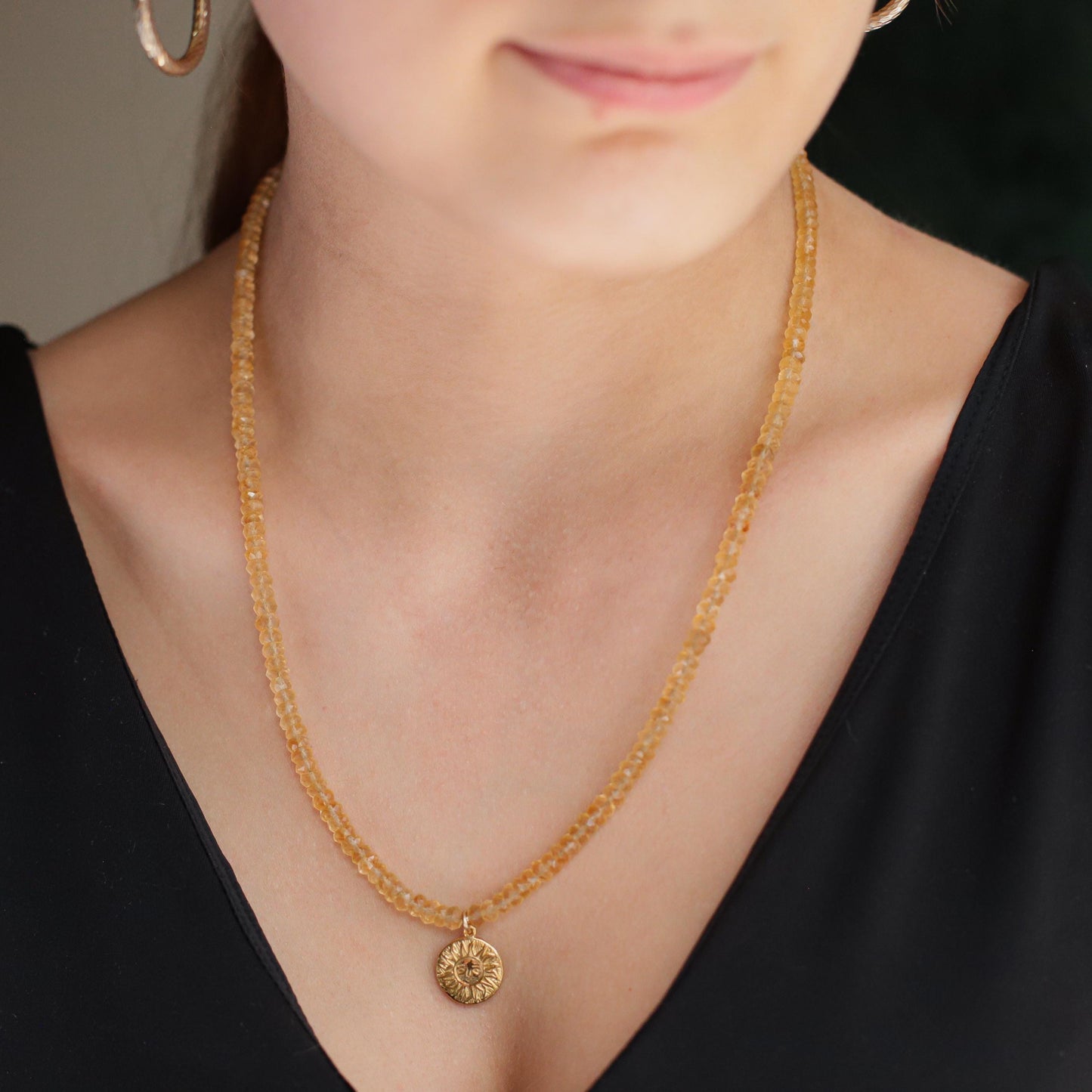 Citrine Sun Necklace by Earthly Abundance featuring a radiant sun-shaped pendant with a large yellow citrine gemstone.