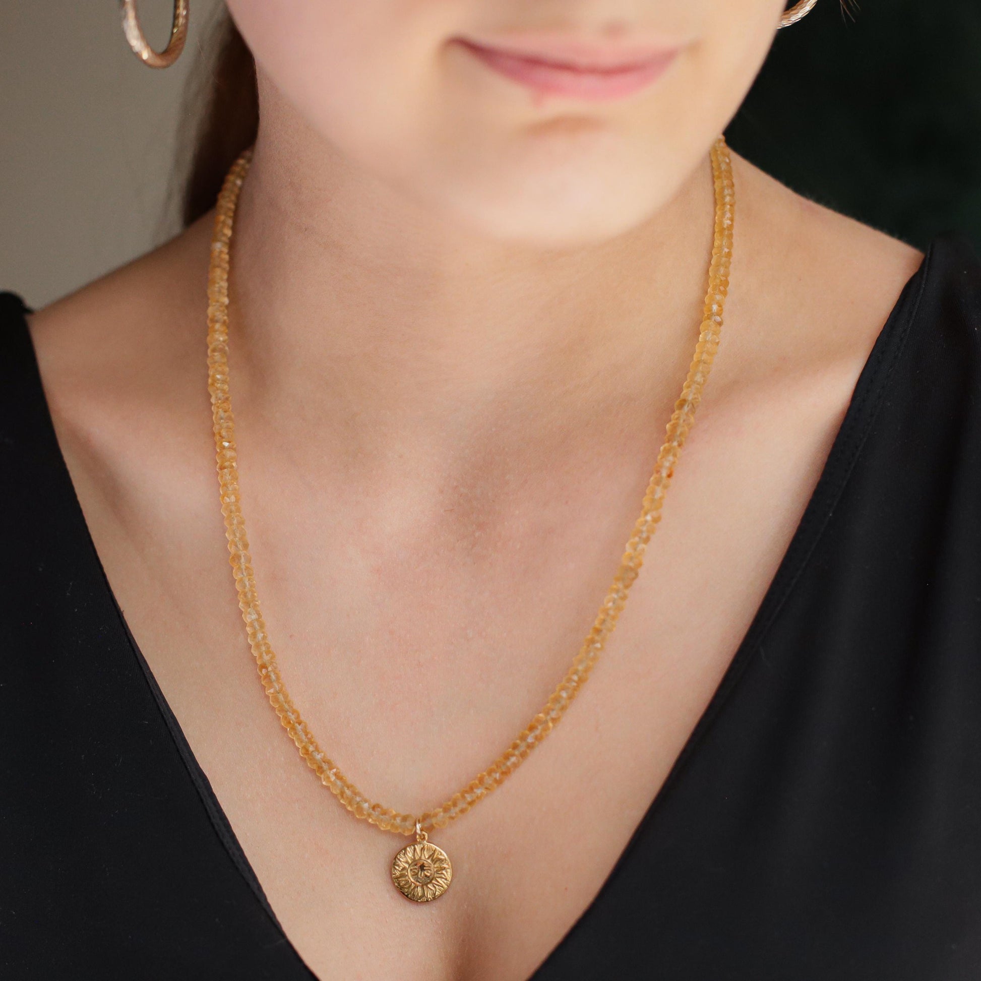 Citrine Sun Necklace by Earthly Abundance featuring a radiant sun-shaped pendant with a large yellow citrine gemstone.