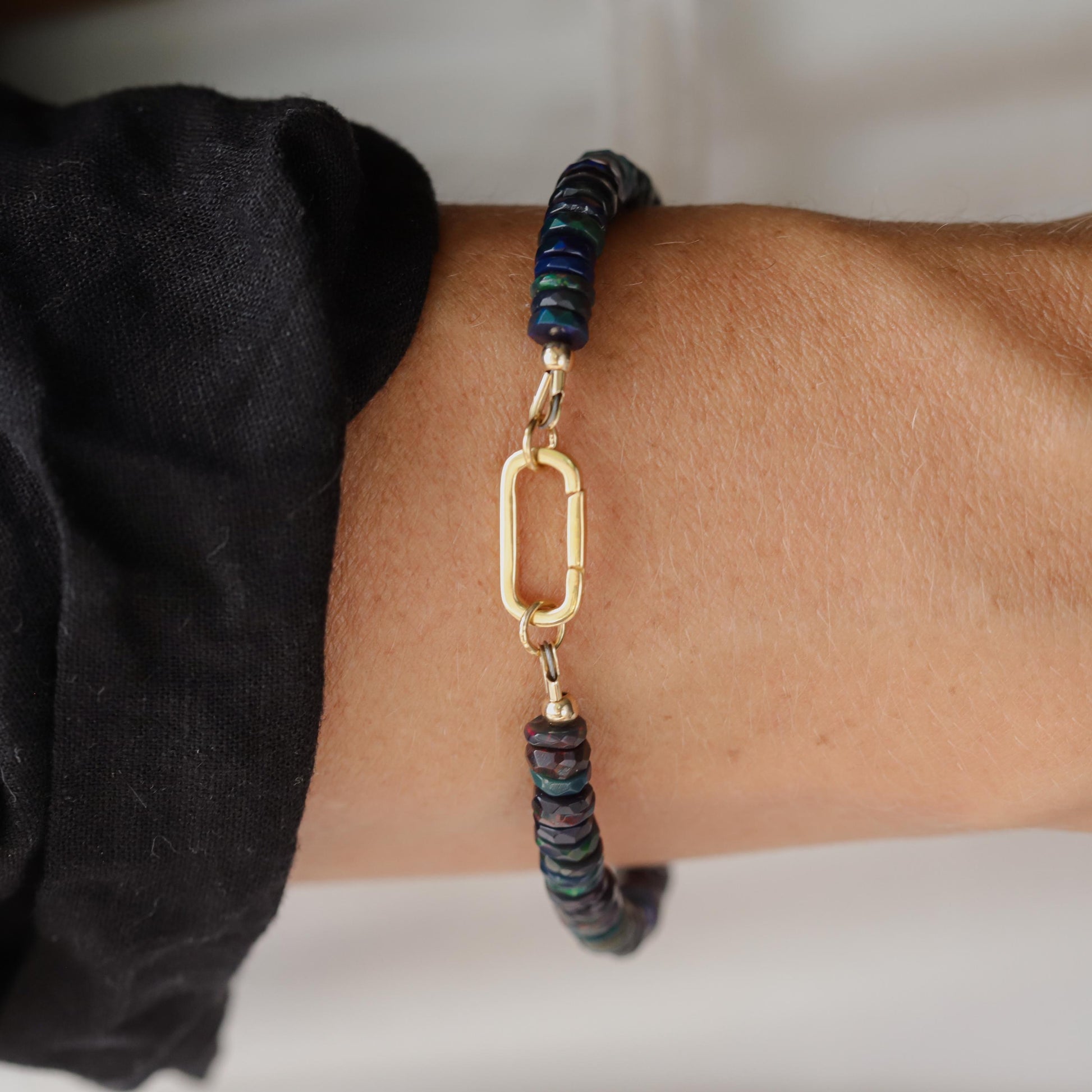 Black Opal Carabiner bracelet by Earthly Abundance featuring a black opal gemstone and metal carabiner clasp.