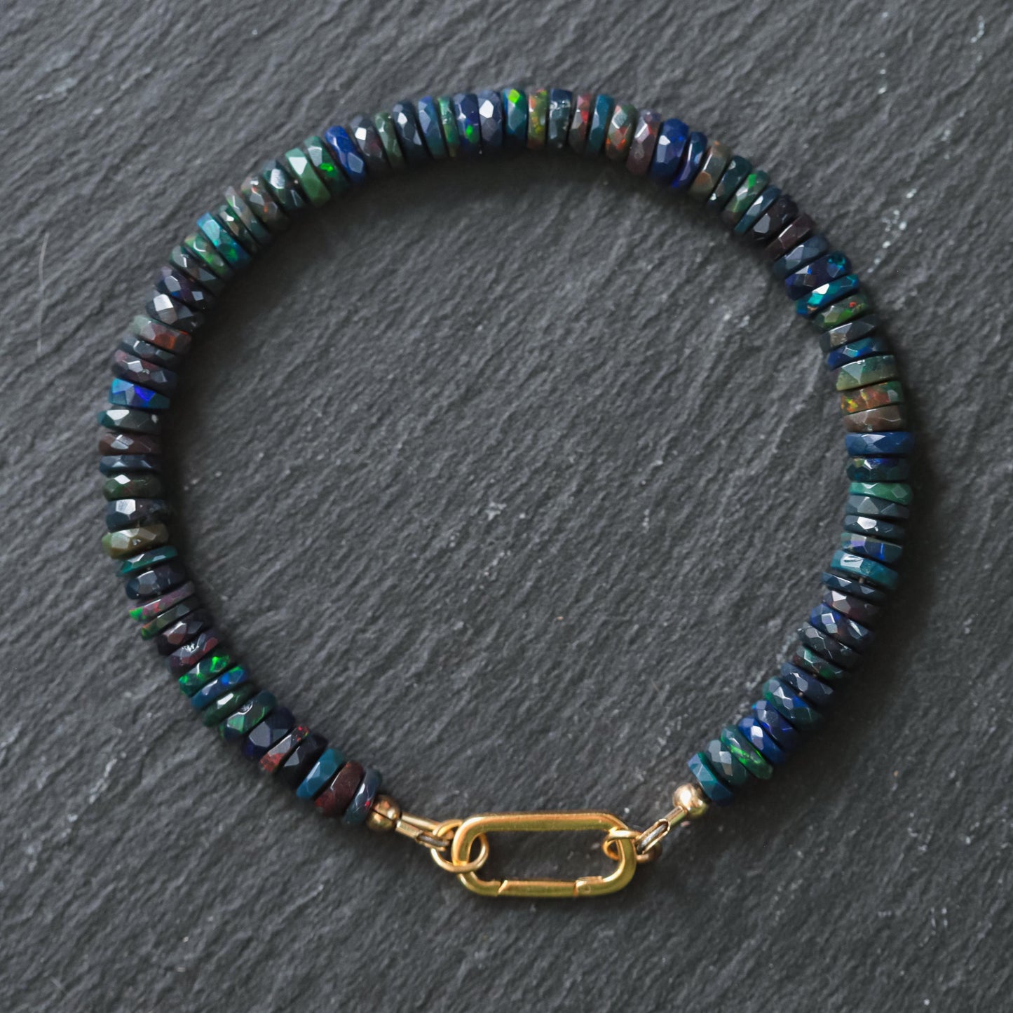 Black Opal Carabiner Bracelet by Earthly Abundance featuring black opal beads and a sturdy metal carabiner clasp.