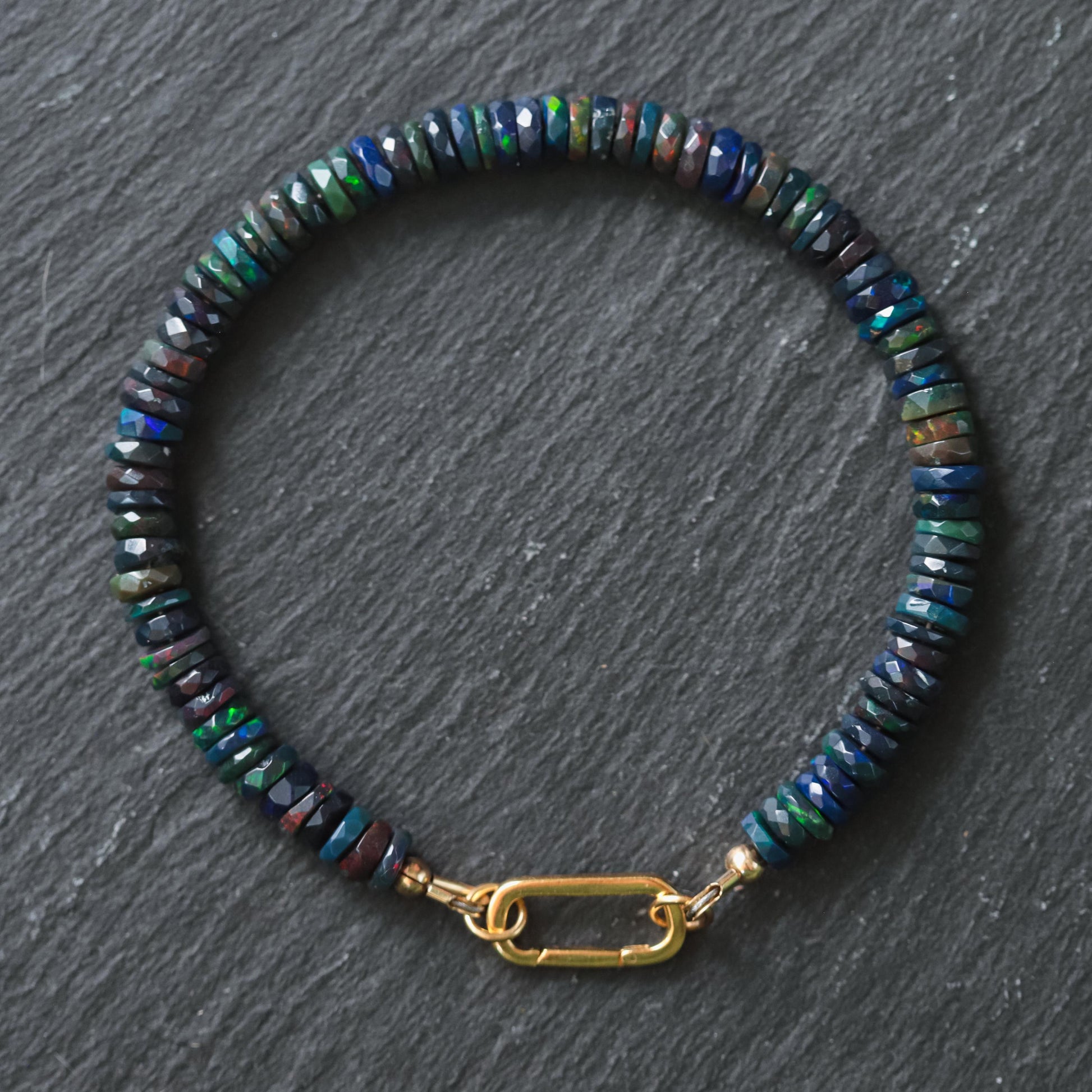Black Opal Carabiner Bracelet by Earthly Abundance featuring black opal beads and a sturdy metal carabiner clasp.