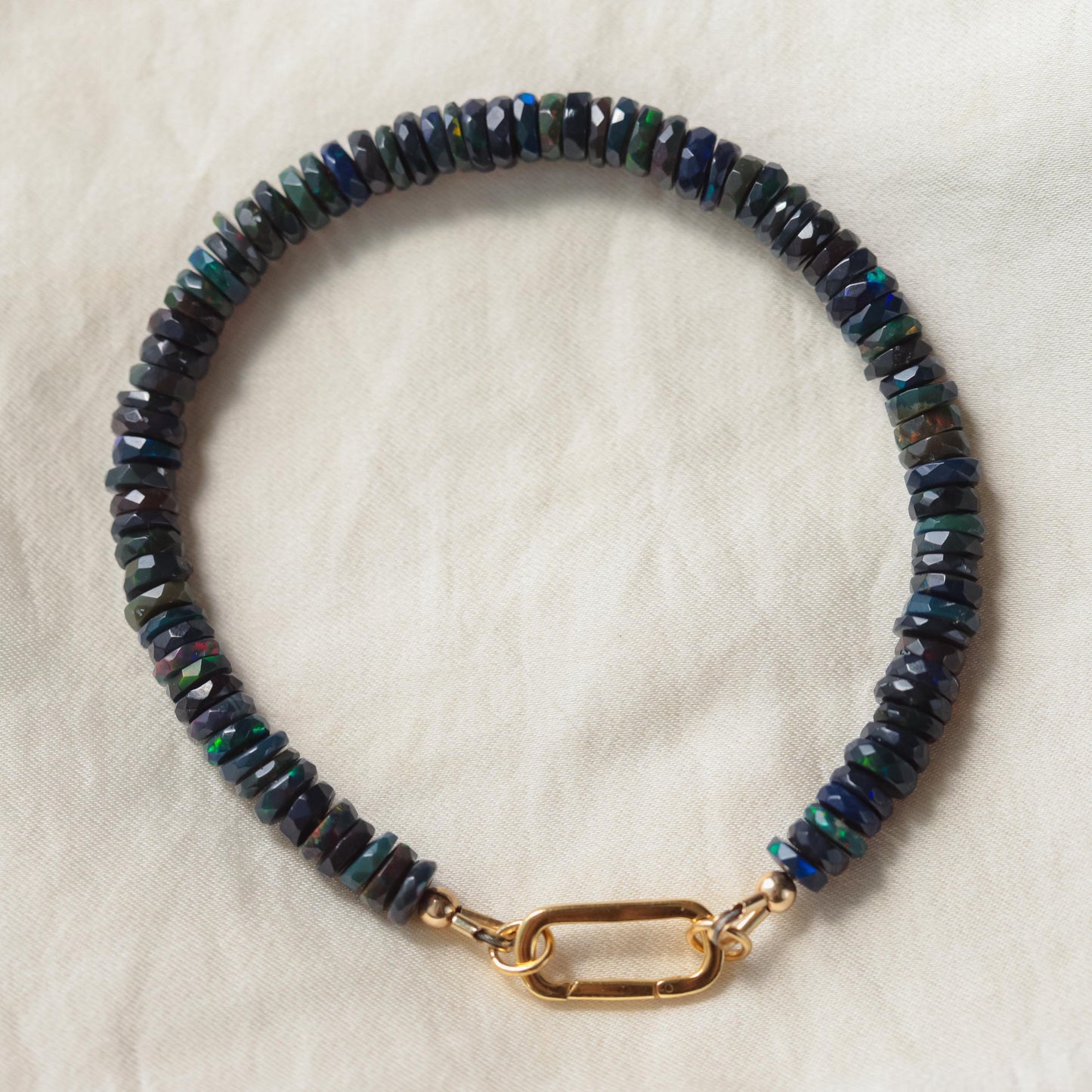 Black Opal Carabiner bracelet by Earthly Abundance featuring a sleek black opal stone on a sturdy carabiner-style clasp.