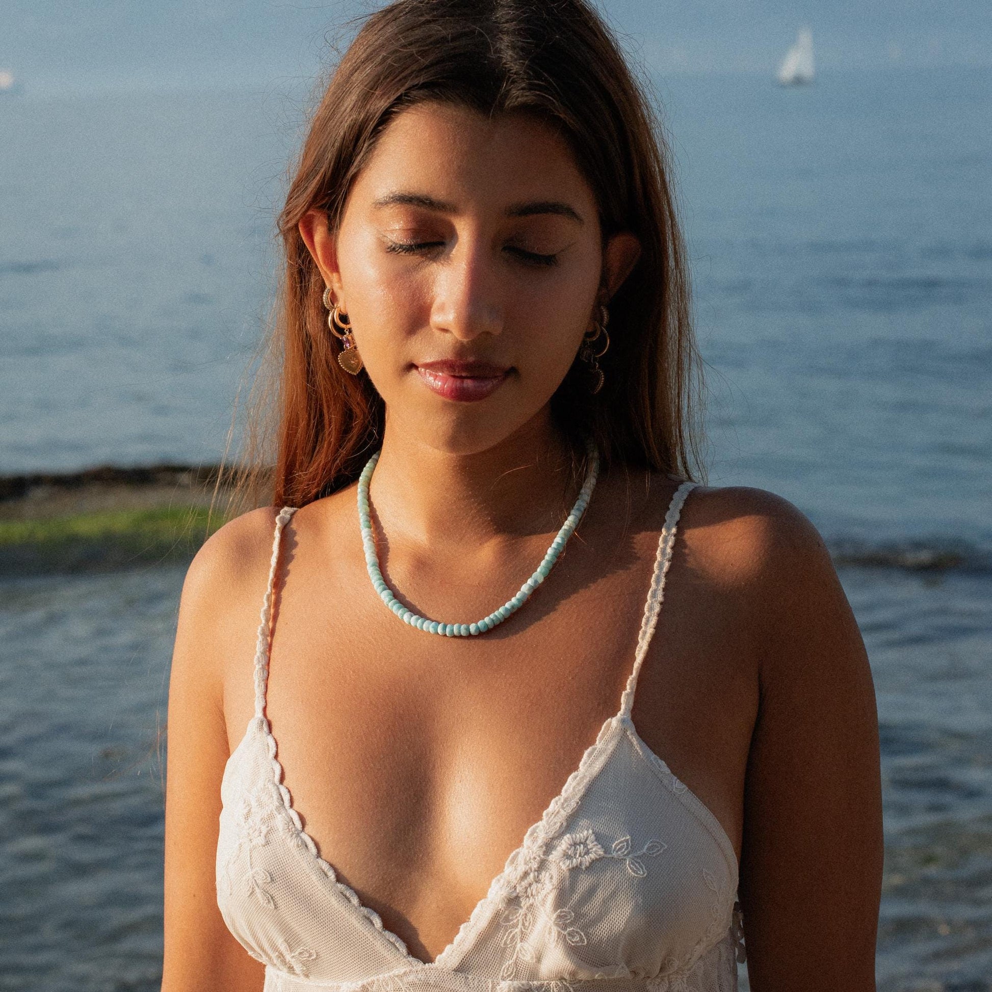 Faceted Larimar rondel necklace by Earthly Abundance featuring smooth blue gemstone beads on a delicate chain.
