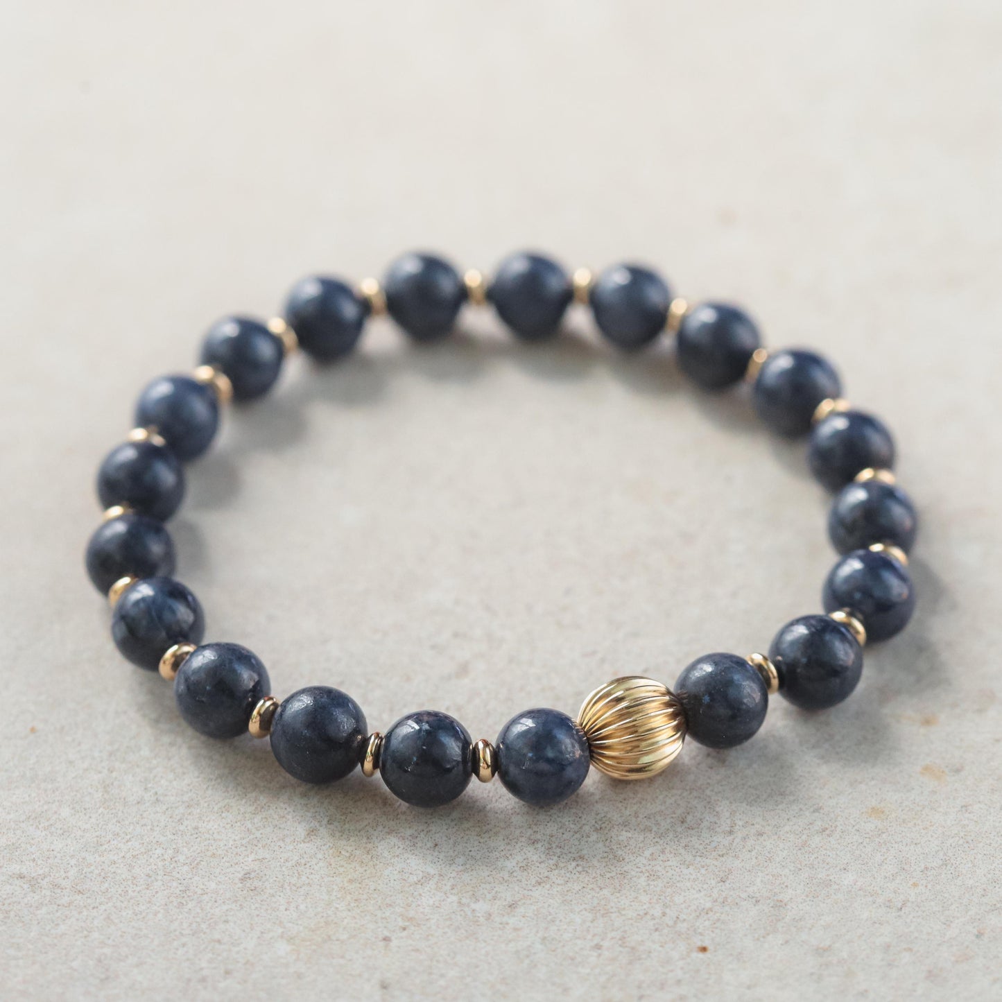 Blue sapphire bracelet in 14K gold with sparkling sapphires, crafted by Earthly Abundance, showcasing elegant jewelry design.