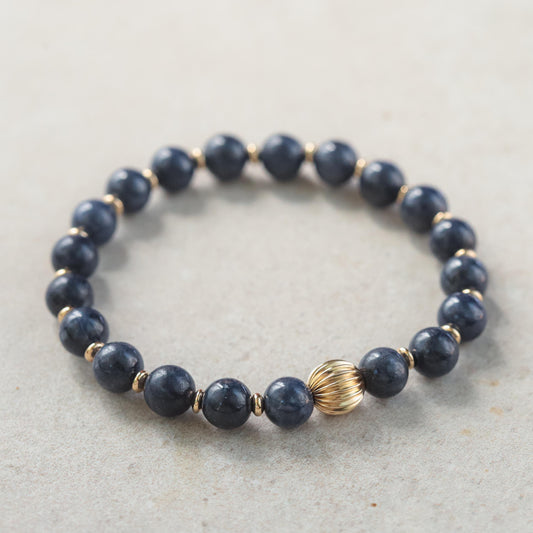Blue sapphire bracelet in 14K gold with sparkling sapphires, crafted by Earthly Abundance, showcasing elegant jewelry design.