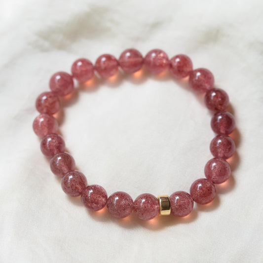 Strawberry Quartz gemstone pendant set in 14K gold with a delicate chain, showcasing vibrant pink hues and natural clarity.