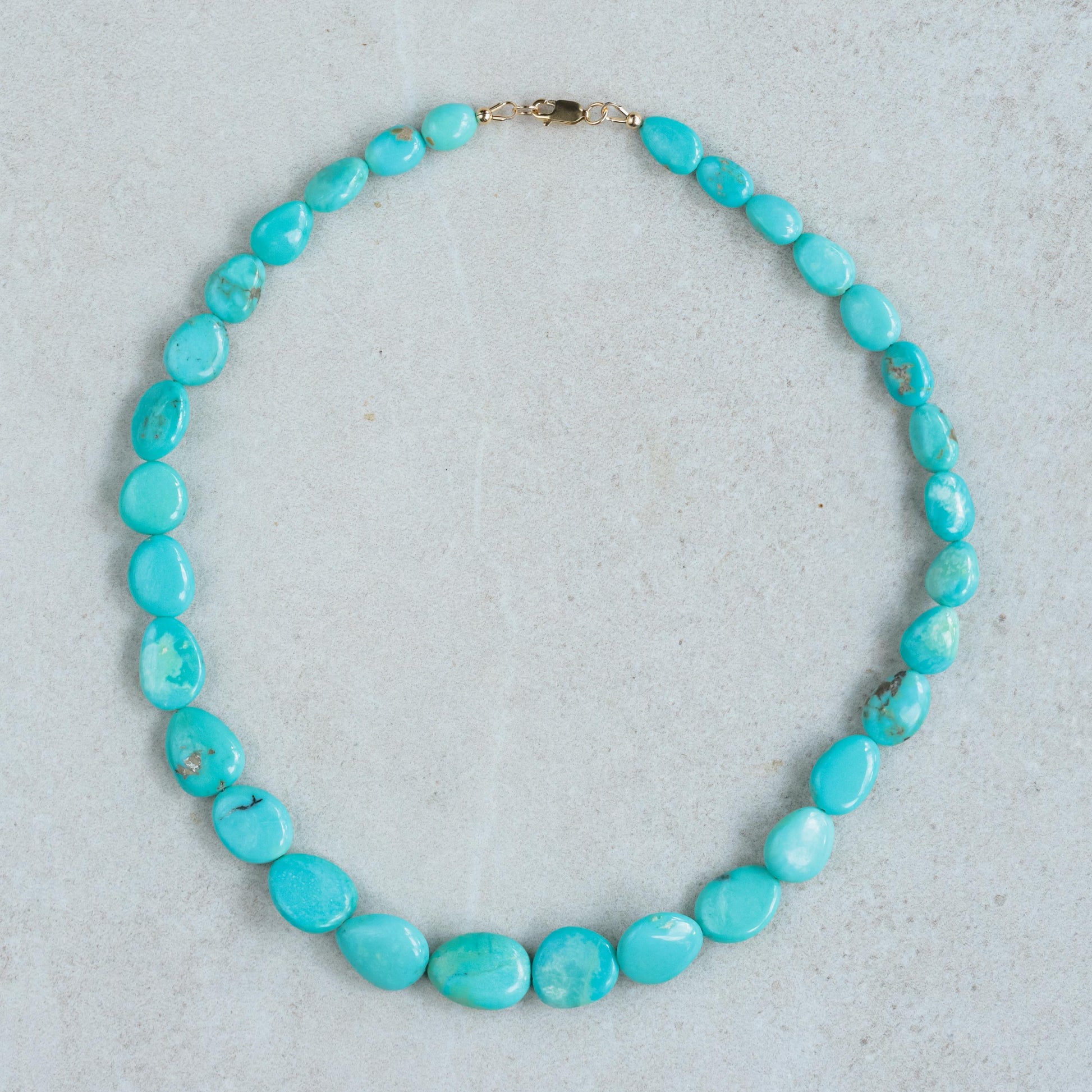 Turquoise Sol Necklace in 14K gold from Earthly Abundance featuring a vibrant turquoise pendant on a delicate gold chain.