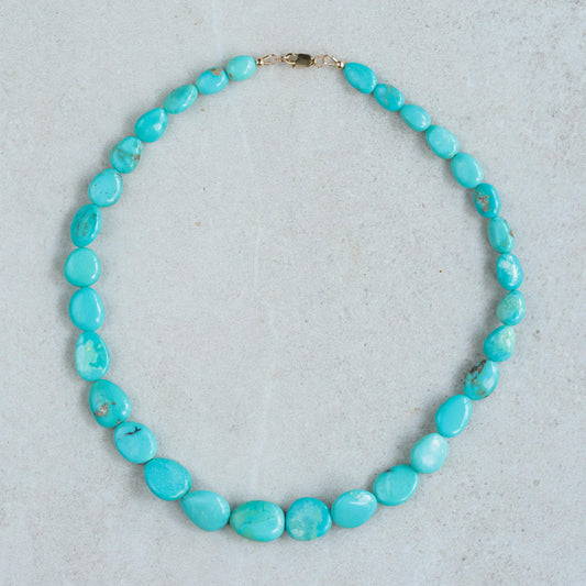 Turquoise Sol Necklace in 14K gold from Earthly Abundance featuring a vibrant turquoise pendant on a delicate gold chain.