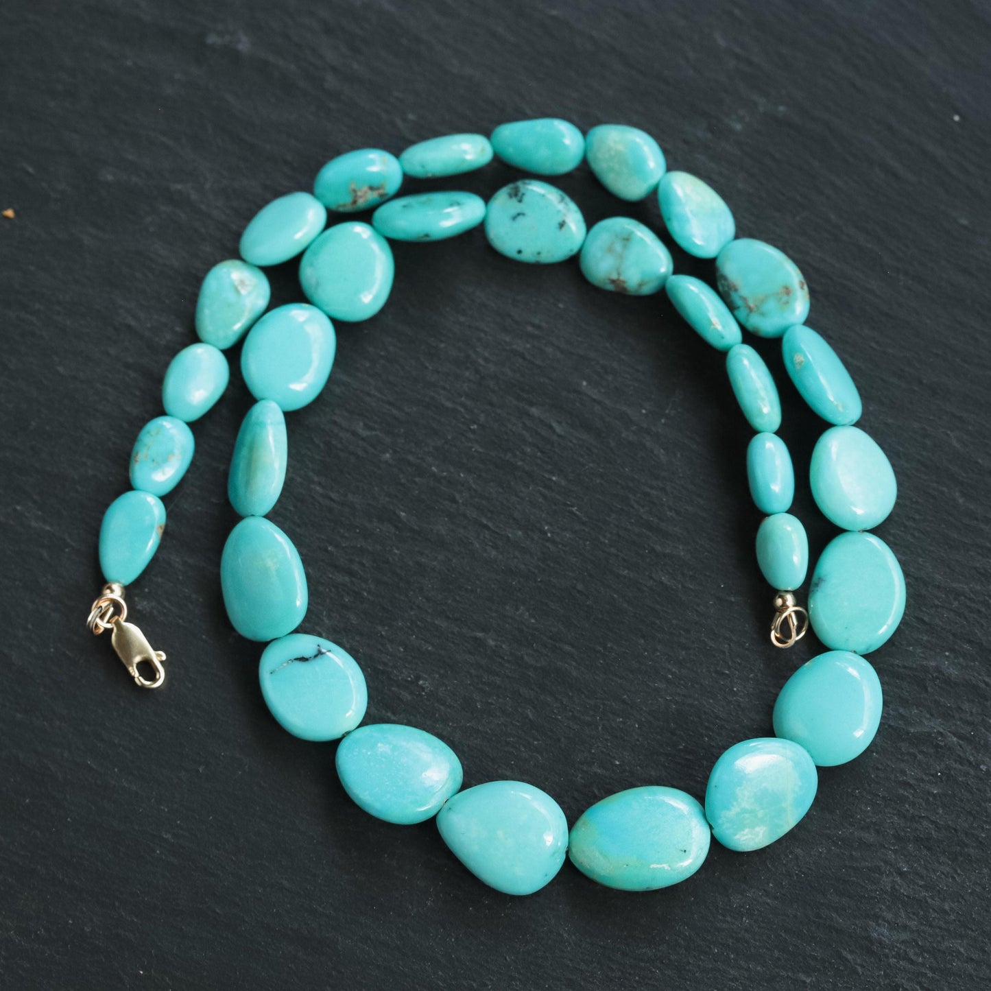 Turquoise Sol Necklace in 14K gold from Earthly Abundance, featuring a vibrant turquoise pendant on a delicate gold chain.