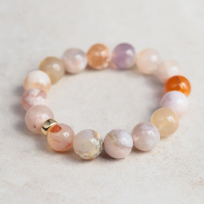 Flower agate bracelet featuring polished stones and a 14K gold clasp, showcasing vibrant floral patterns and natural gemstone beauty.