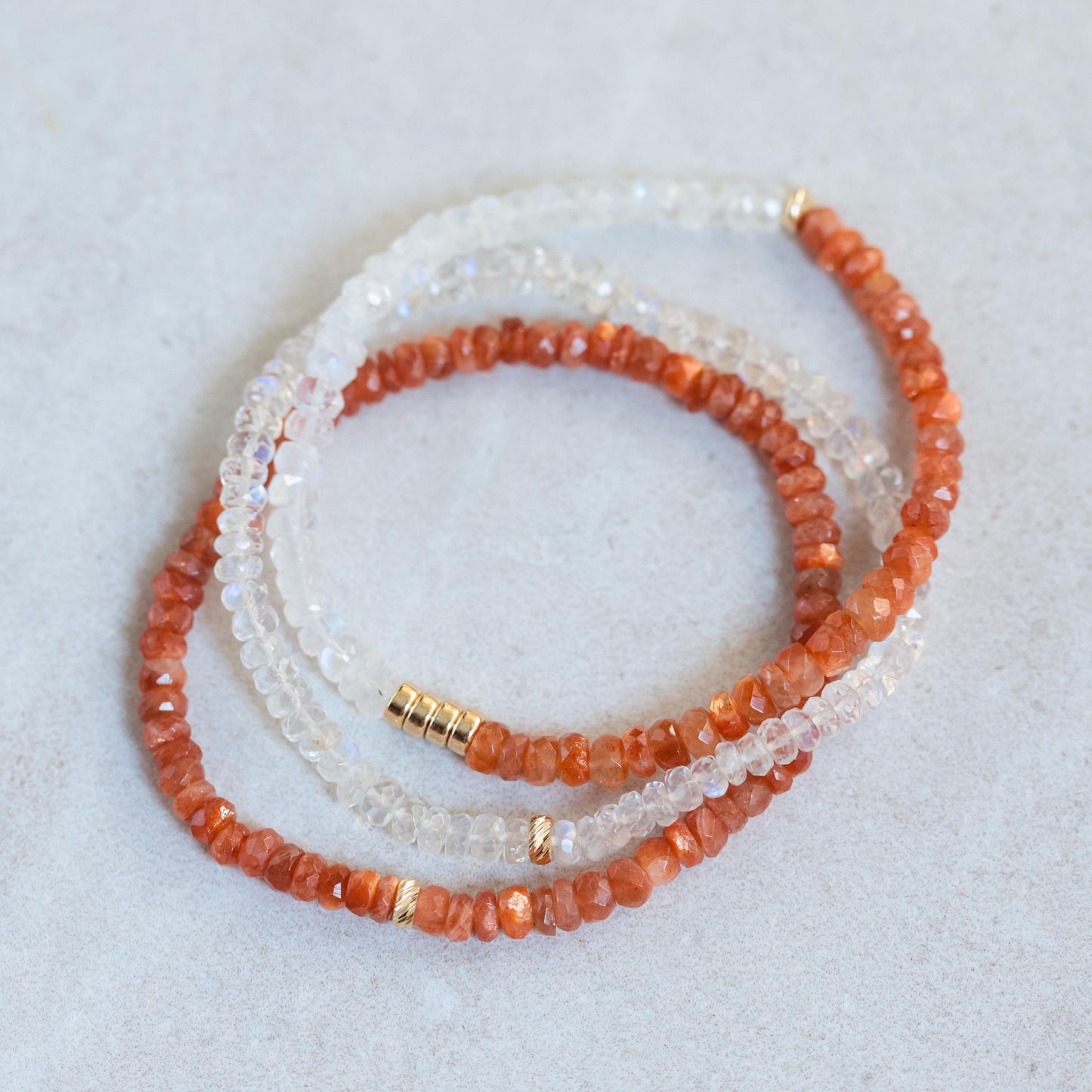 Sunstone bracelet with 14K gold clasp from Earthly Abundance, showcasing polished orange gemstone beads on a delicate stretch cord.