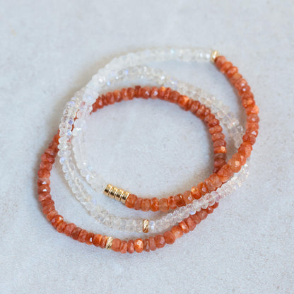 Sunstone bracelet with 14K gold clasp from Earthly Abundance, showcasing polished orange gemstone beads on a delicate stretch cord.