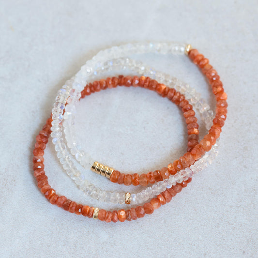 Sunstone bracelet with 14K gold clasp from Earthly Abundance, showcasing polished orange gemstone beads on a delicate stretch cord.