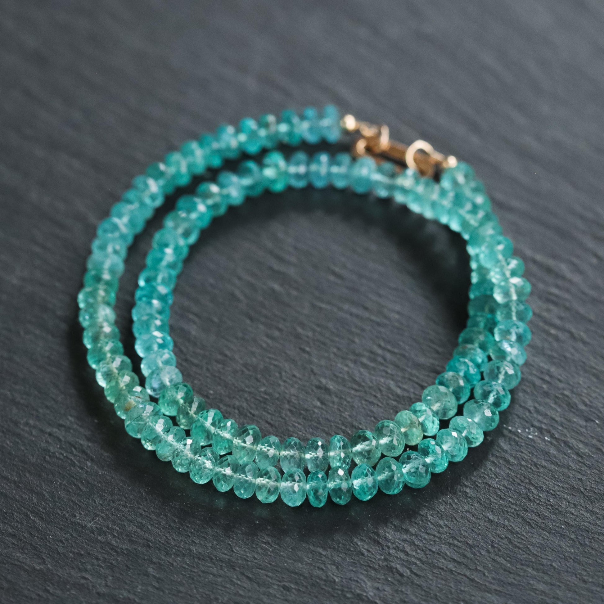 Bi-color apatite necklace with 14K gold chain, featuring vibrant blue and green hues, from Earthly Abundance.
