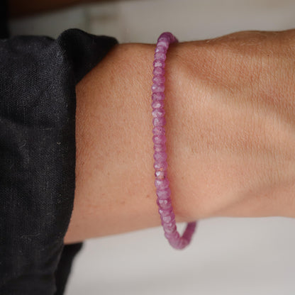 Earthly Abundance Rosata African Ruby bracelet featuring polished red ruby beads on a delicate elastic band.