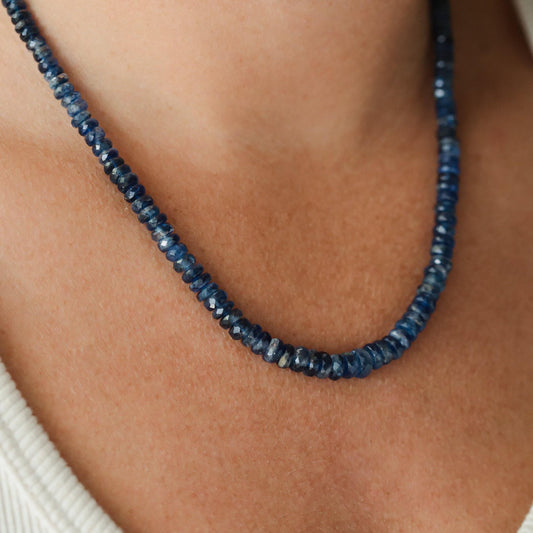 Kyanite necklace with polished blue stones on a silver chain, showcasing natural gemstone details from Earthly Abundance.