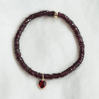 Earthly Abundance garnet heart bracelet featuring polished red gemstone hearts on a delicate chain.