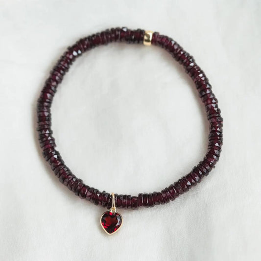 Earthly Abundance garnet heart bracelet featuring polished red gemstone hearts on a delicate chain.