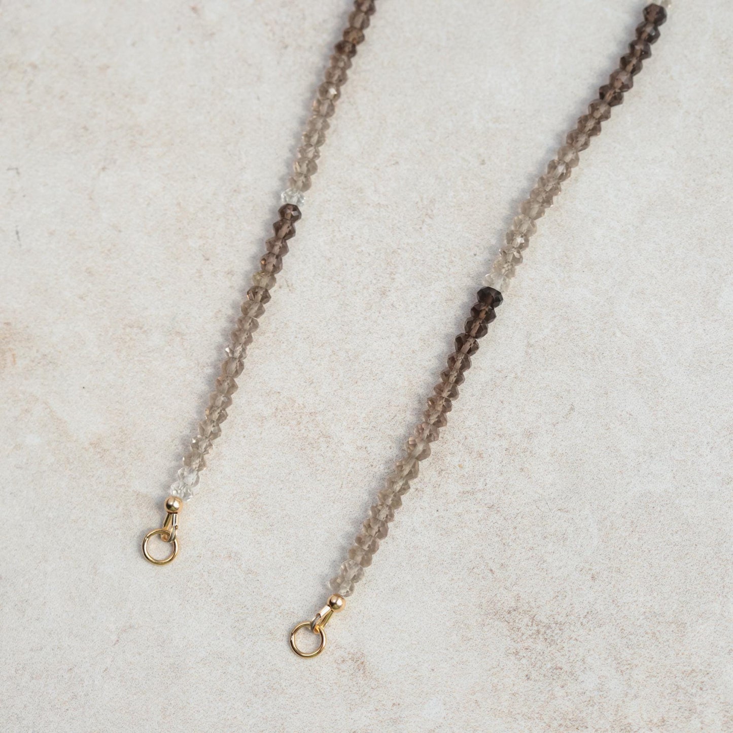 Smoky quartz triangle pendant necklace in 14K gold, featuring a natural gemstone on a delicate chain.