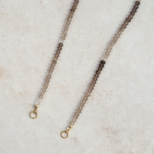 Smoky quartz triangle pendant necklace in 14K gold, featuring a natural gemstone on a delicate chain.