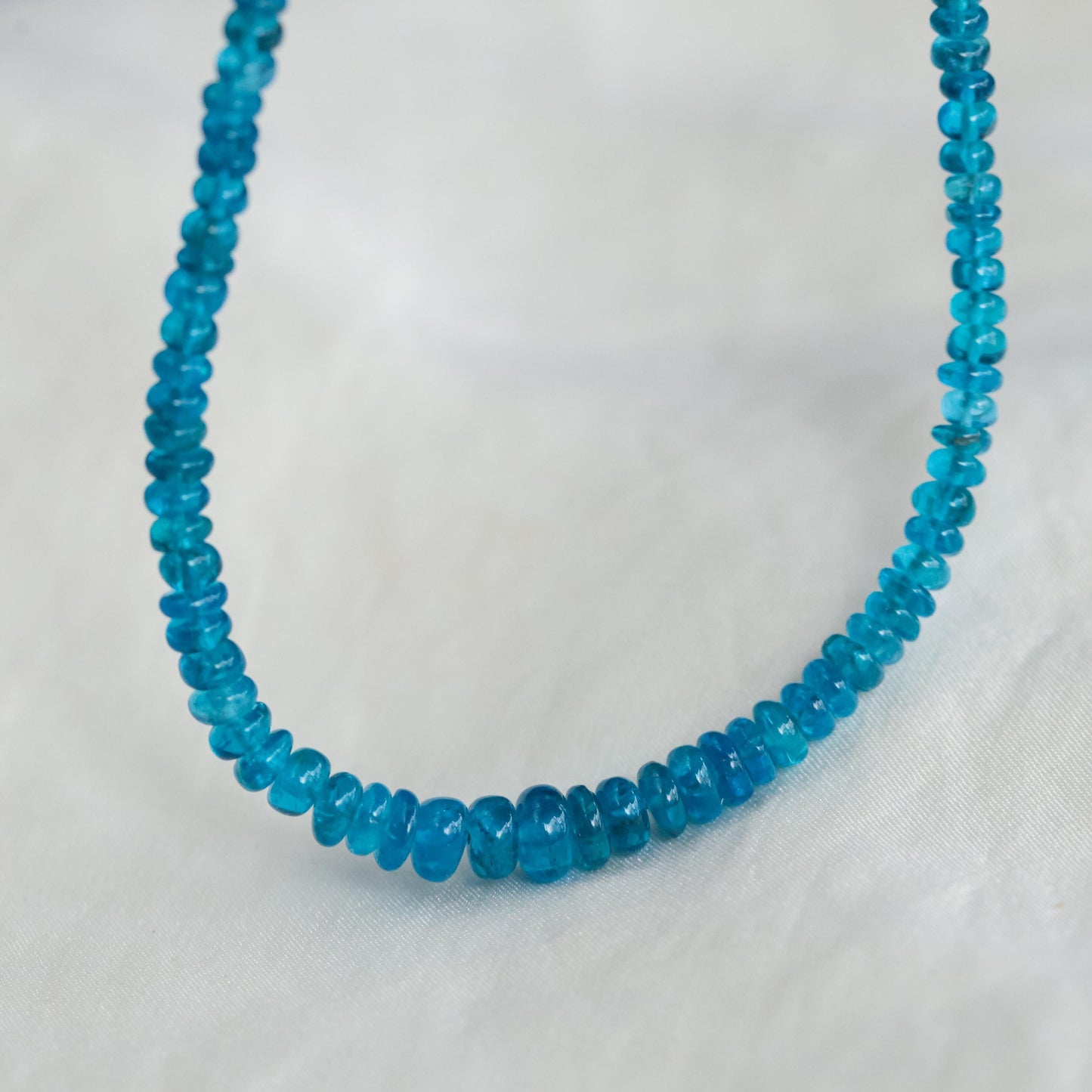 Gemmy apatite necklace featuring vibrant blue-green stones on a silver chain, from Earthly Abundance.