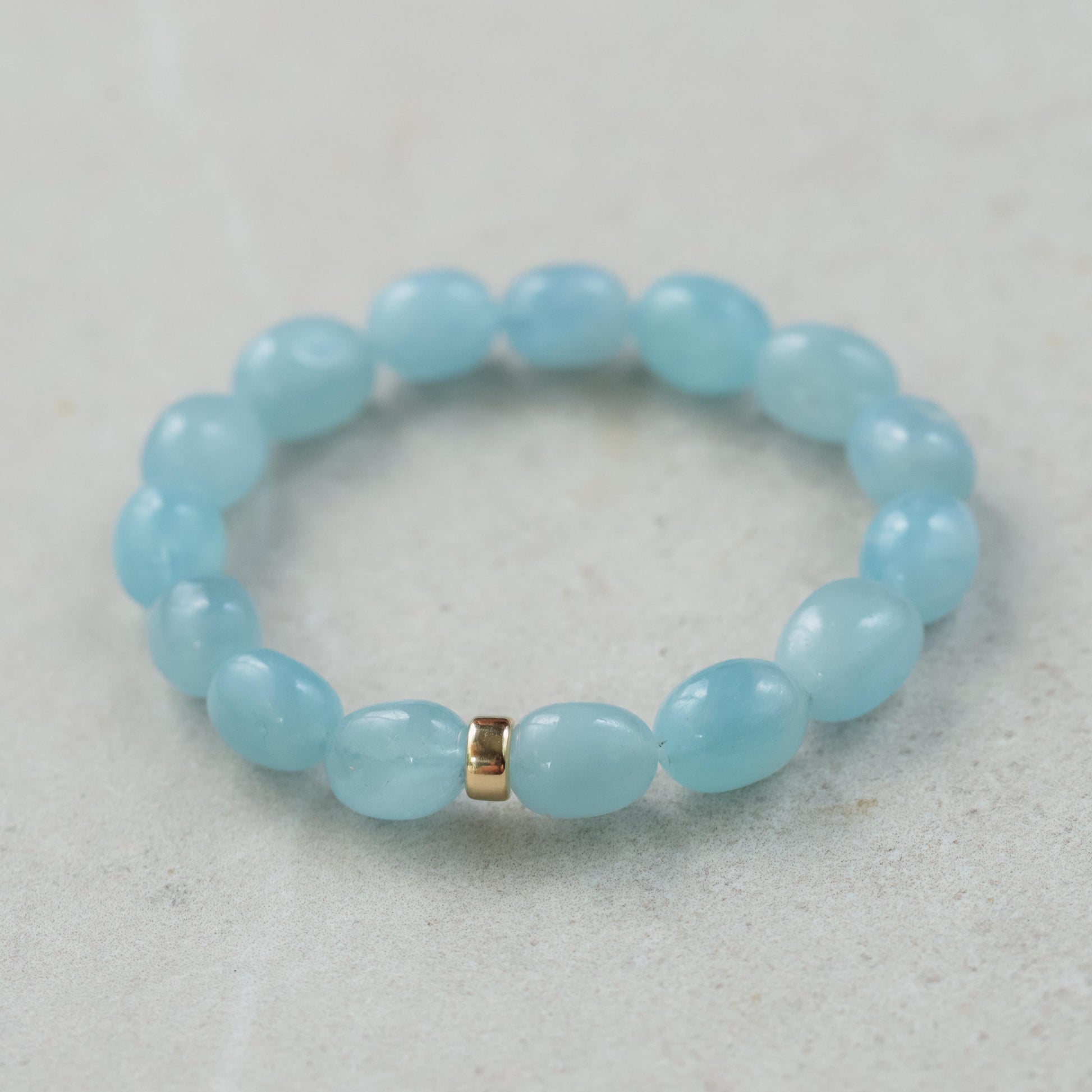 Aquamarine nugget bracelet with 14K gold clasp, featuring polished aquamarine stones on a delicate gold chain.