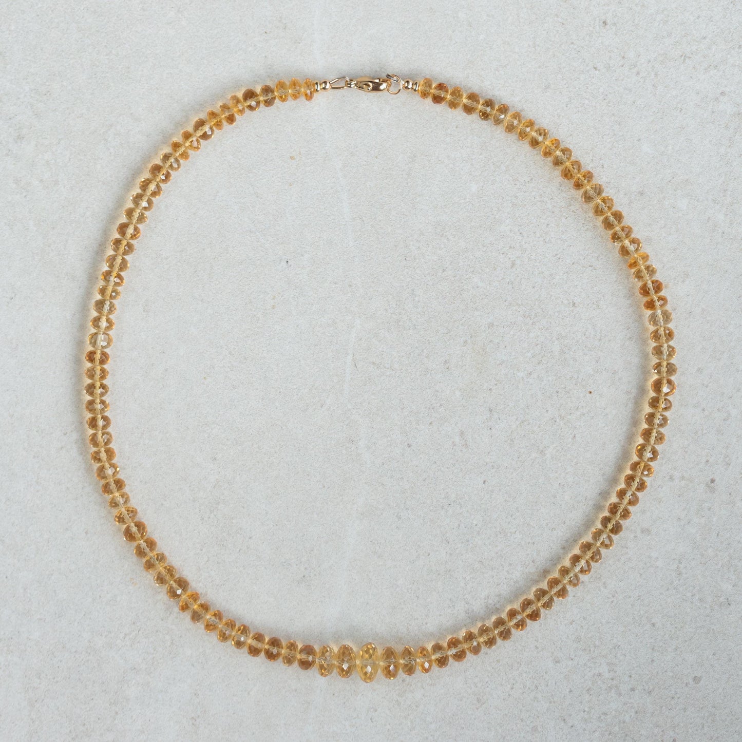 Earthly Abundance Citrine Honey Glow necklace featuring a warm amber-colored citrine pendant on a delicate chain.