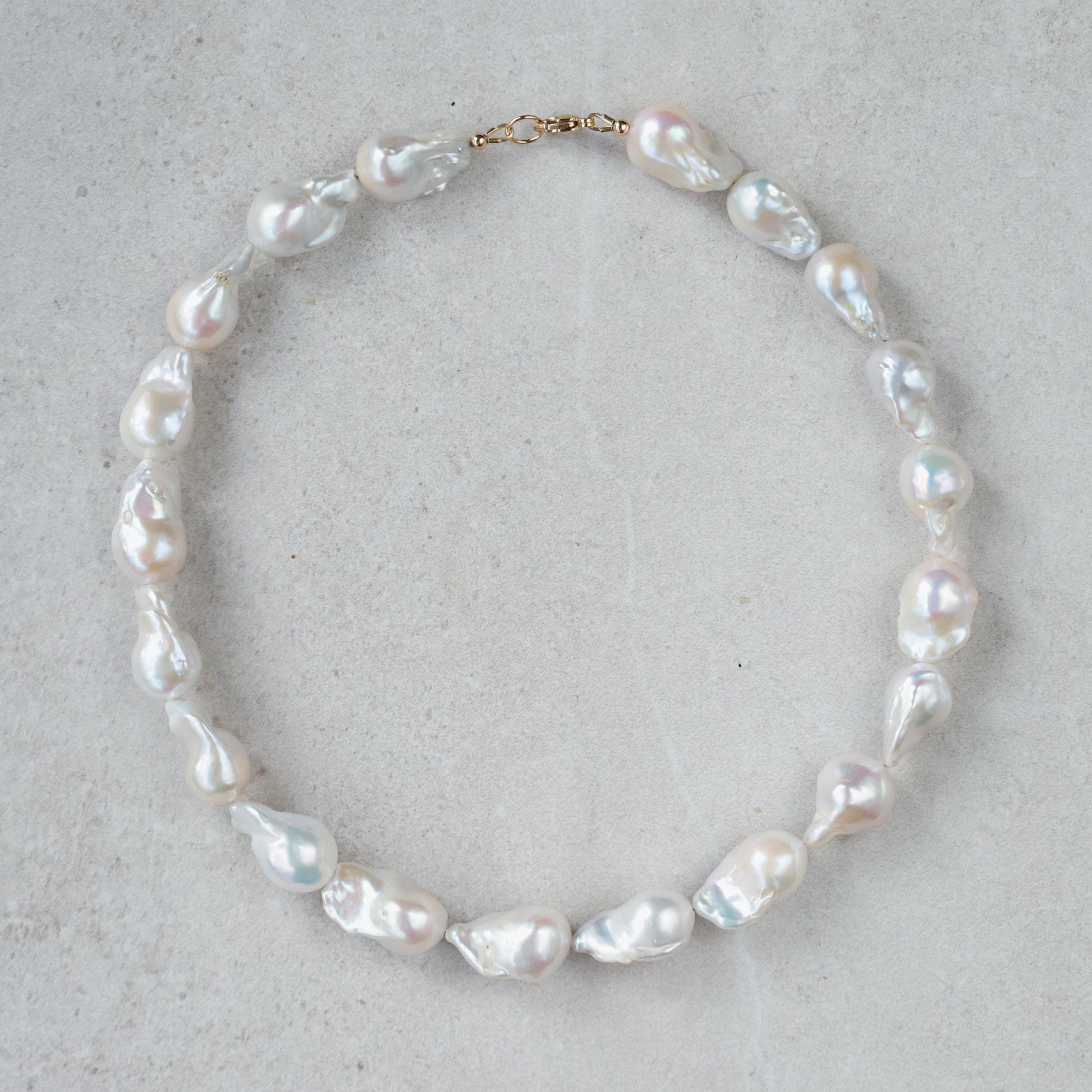 Elegant Baroque Pearl necklace by Earthly Abundance featuring irregularly shaped lustrous pearls on a delicate chain.