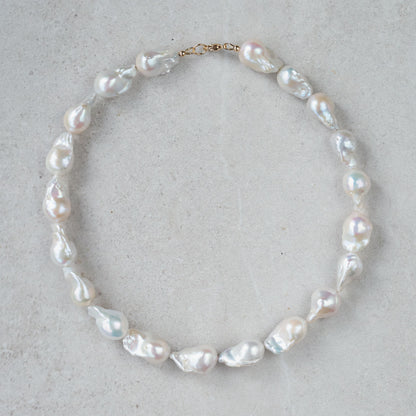 Elegant Baroque Pearl necklace by Earthly Abundance featuring irregularly shaped lustrous pearls on a delicate chain.