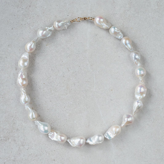 Elegant Baroque Pearl necklace by Earthly Abundance featuring irregularly shaped lustrous pearls on a delicate chain.
