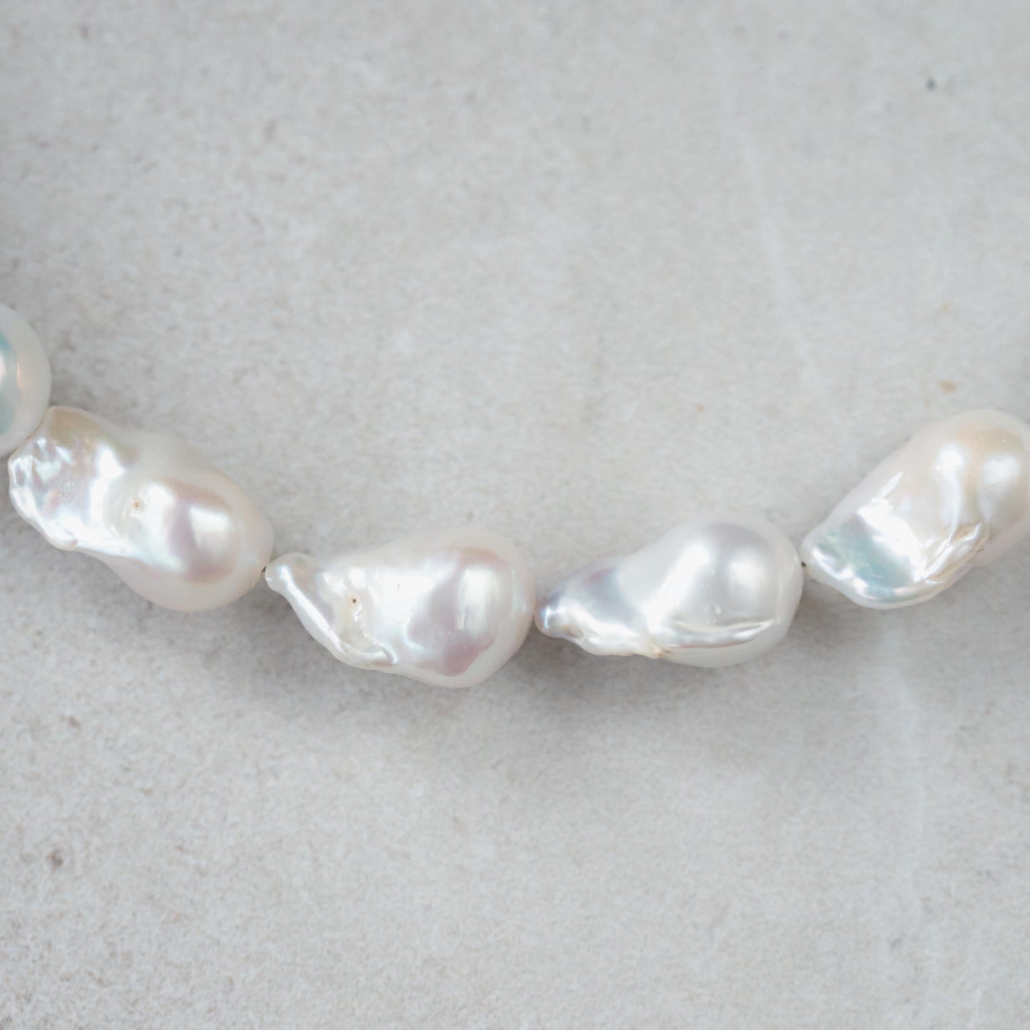 Elegant Baroque Pearl necklace by Earthly Abundance featuring irregular-shaped pearls on a delicate chain.