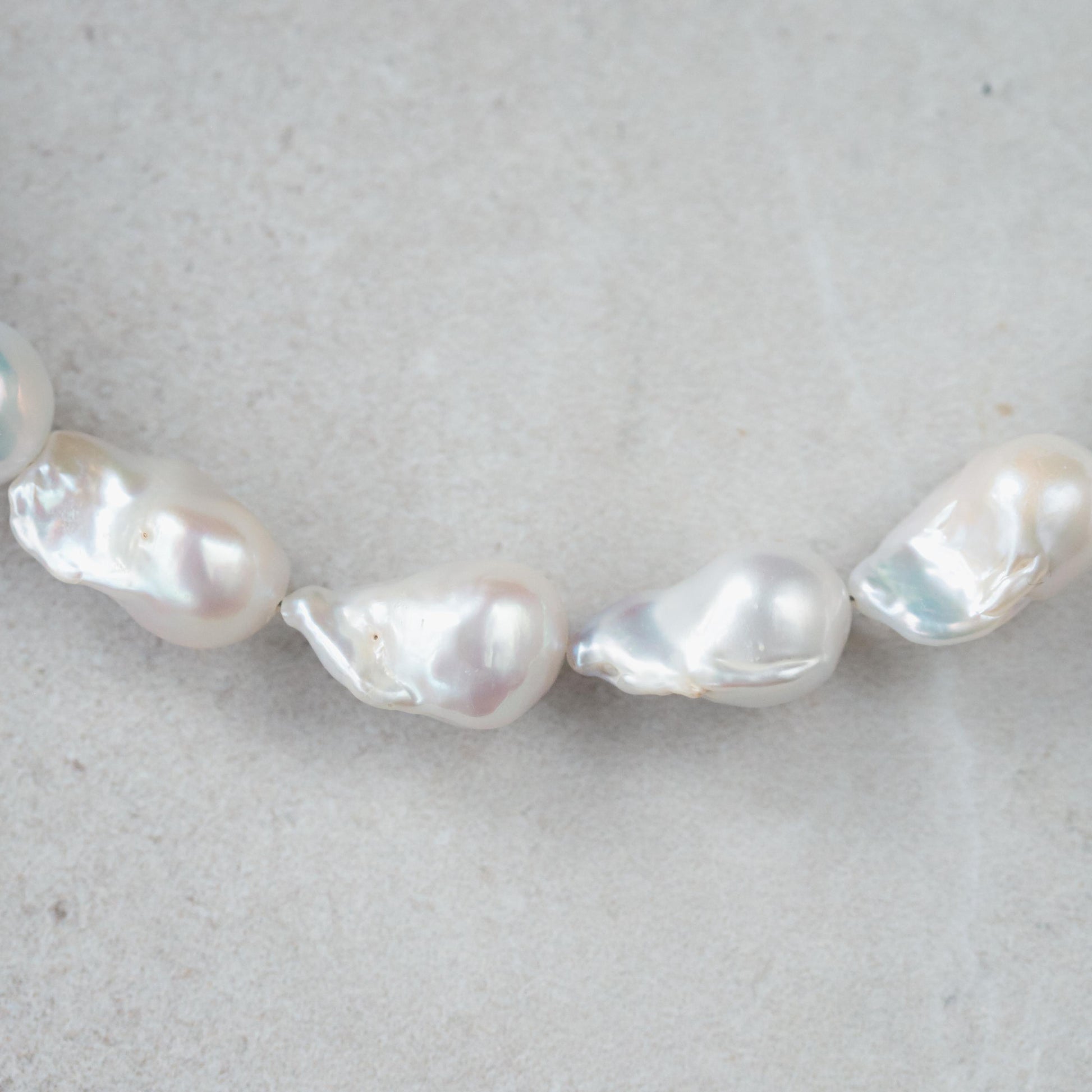 Elegant Baroque Pearl necklace by Earthly Abundance featuring irregular-shaped pearls on a delicate chain.