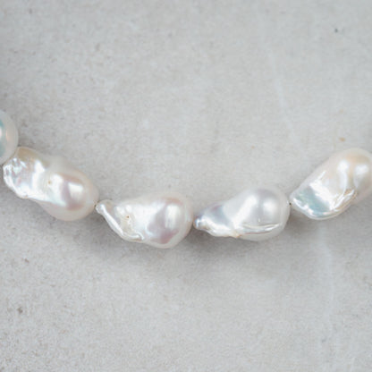 Elegant Baroque Pearl necklace by Earthly Abundance featuring irregular-shaped pearls on a delicate chain.