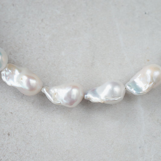 Elegant Baroque Pearl necklace by Earthly Abundance featuring irregular-shaped pearls on a delicate chain.