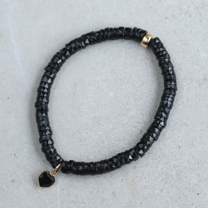 Black spinel heart bracelet with 14K gold accents, showcasing elegant jewelry design by Earthly Abundance.