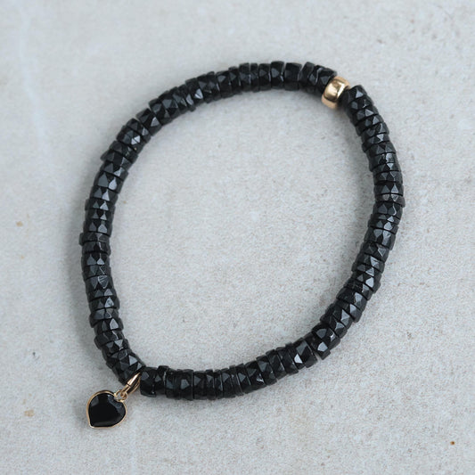 Black spinel heart bracelet with 14K gold accents, showcasing elegant jewelry design by Earthly Abundance.