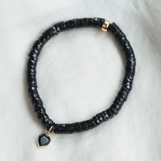 Black spinel heart bracelet with 14K gold accents from Earthly Abundance, featuring a delicate chain and heart-shaped black spinel charms.
