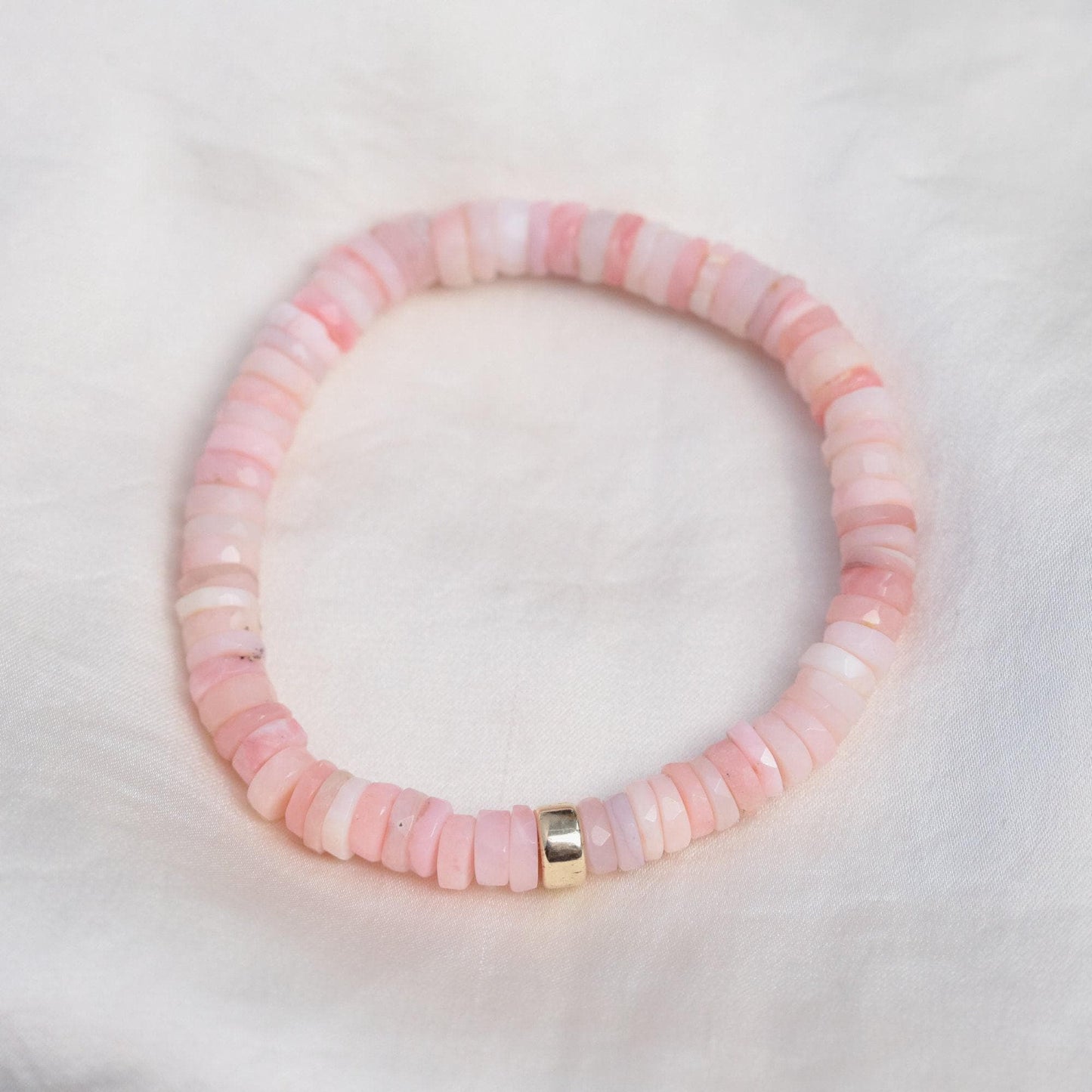 Pink Opal Heishi bracelet by Earthly Abundance featuring small, colorful stone beads on a stretchy elastic band.