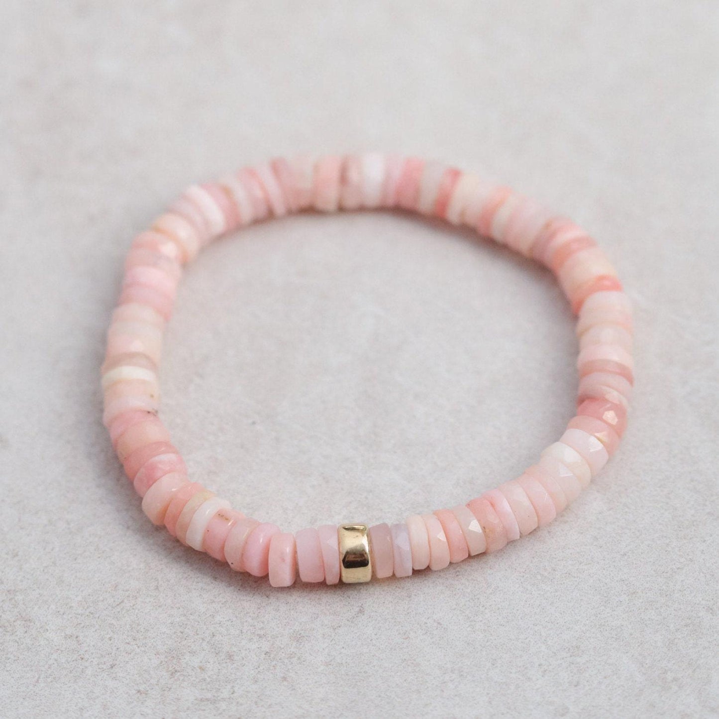 Pink Opal Heishi bracelet from Earthly Abundance featuring small, colorful gemstone beads on a stretchy cord.