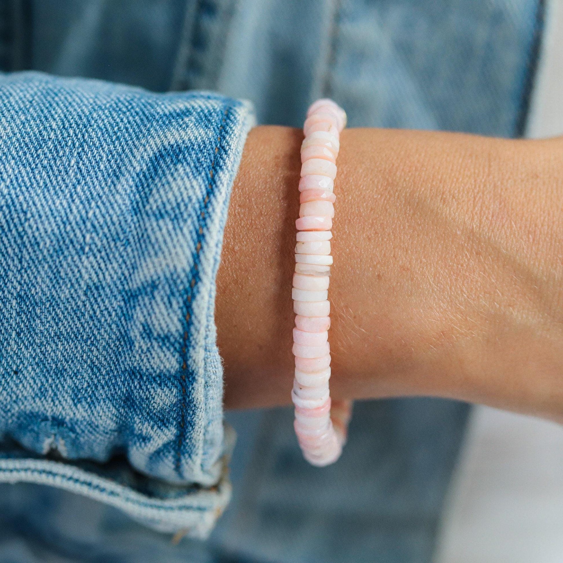 Pink Opal Heishi bracelet from Earthly Abundance featuring small, colorful stone beads on a delicate elastic band.